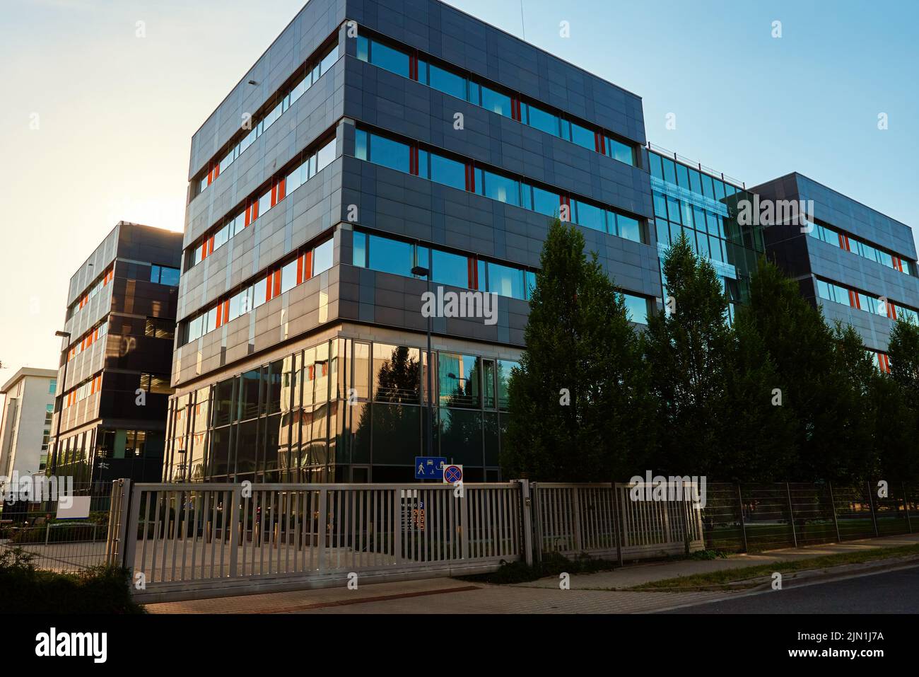 Facade of buiding with green trees, Modern office building in city for