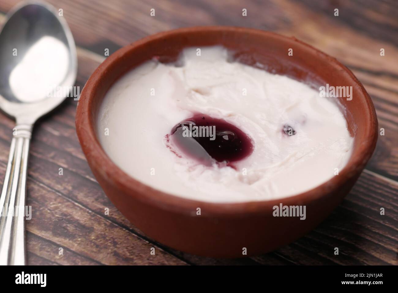 fresh blueberry yogurt in a bowl on table  Stock Photo