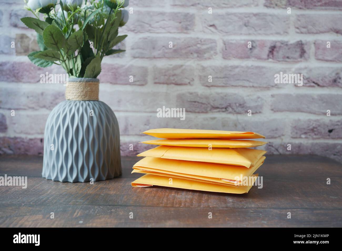 yellow paper bubble envelope on table  Stock Photo