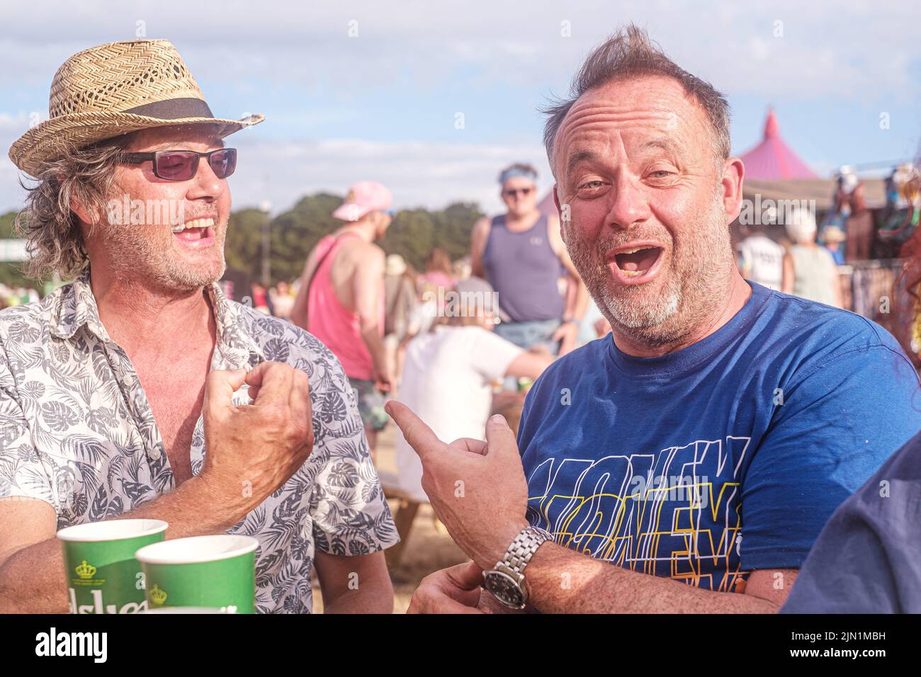 Joyful men attending the Latitude Music Festival, Suffolk, UK Stock