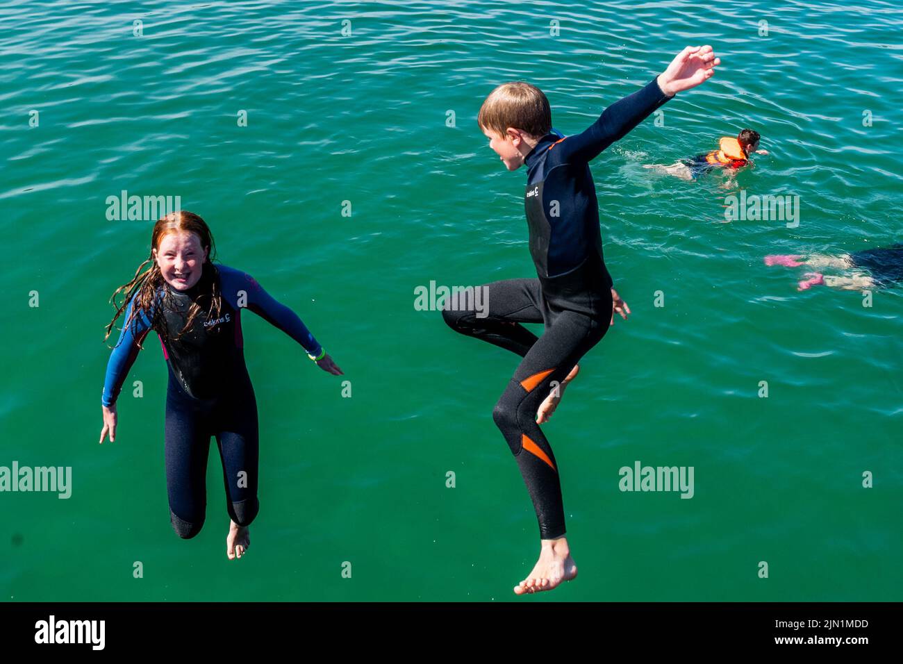 Rosscarbery, West Cork, Ireland. 8th Aug, 2022. Rosscarbery Pier was very busy today with people taking a dip and jumping into the water to cool off on a day with temperatures hitting 21C. Enjoying the sunny weather were Mary and Paddy O'Regan from Clonakilty. Credit: AG News/Alamy Live News Stock Photo
