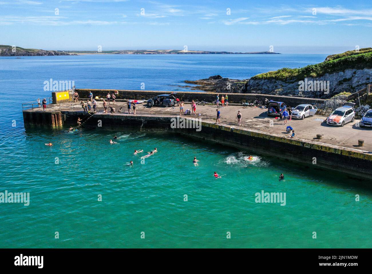 Rosscarbery, West Cork, Ireland. 8th Aug, 2022. Rosscarbery Pier was very busy today with people taking a dip and jumping into the water to cool off on a day with temperatures hitting 21C. Credit: AG News/Alamy Live News Stock Photo