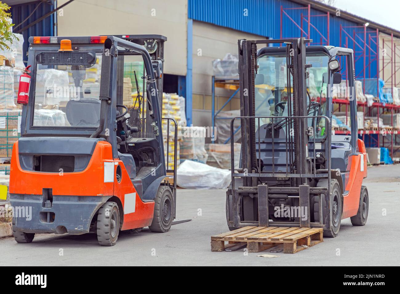 Two Forklift Machine Vehicles at Open Warehouse Storage Transport Stock Photo