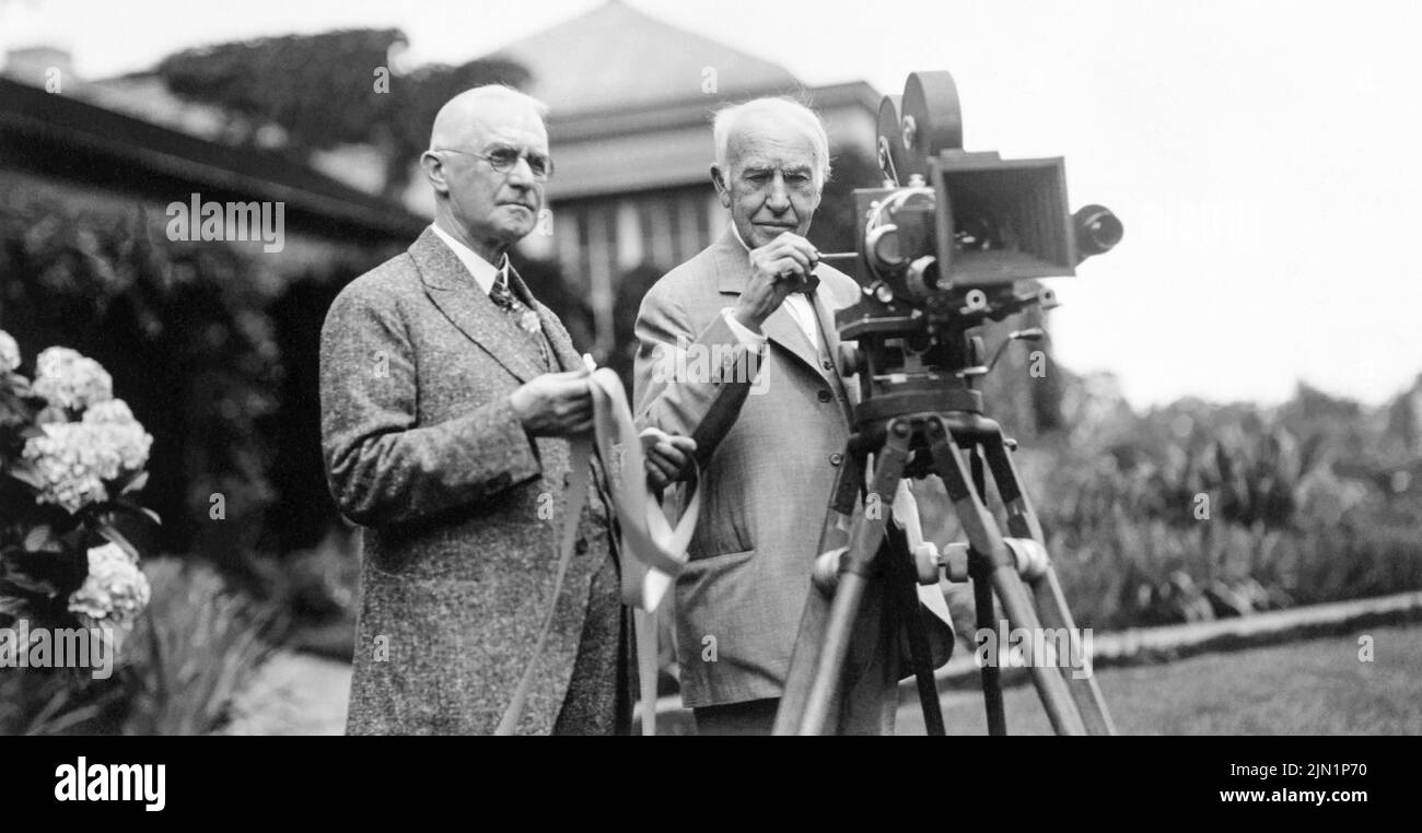 George Eastman (left) and Thomas Edison in July 1928, with motion picture camera at Eastman's house in Rochester, New York, where a demonstration of the new Kodacolor film was being held. (USA) Stock Photo