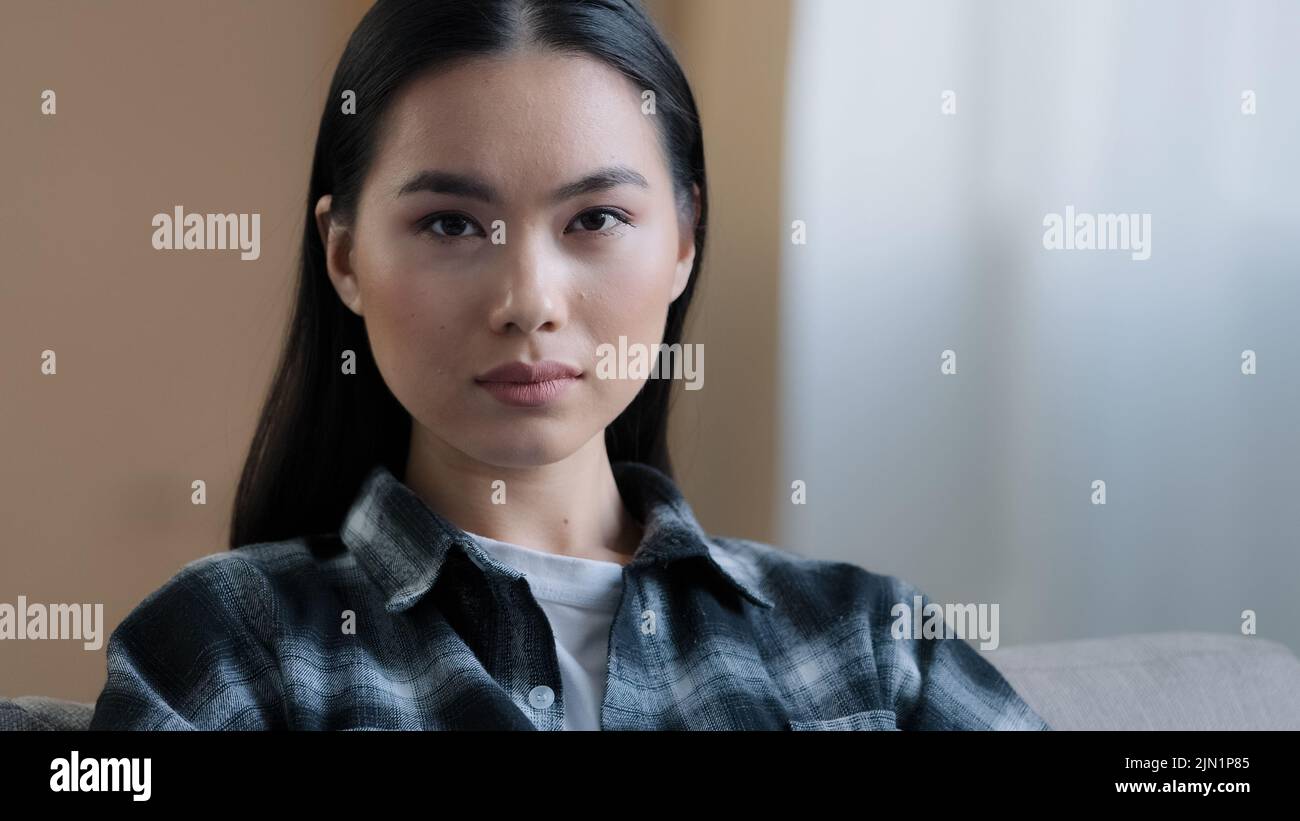 Asian ethnicity female face calm expression serious Korean 20s girl client model with black smooth hair perfect skin millennial single woman looking Stock Photo