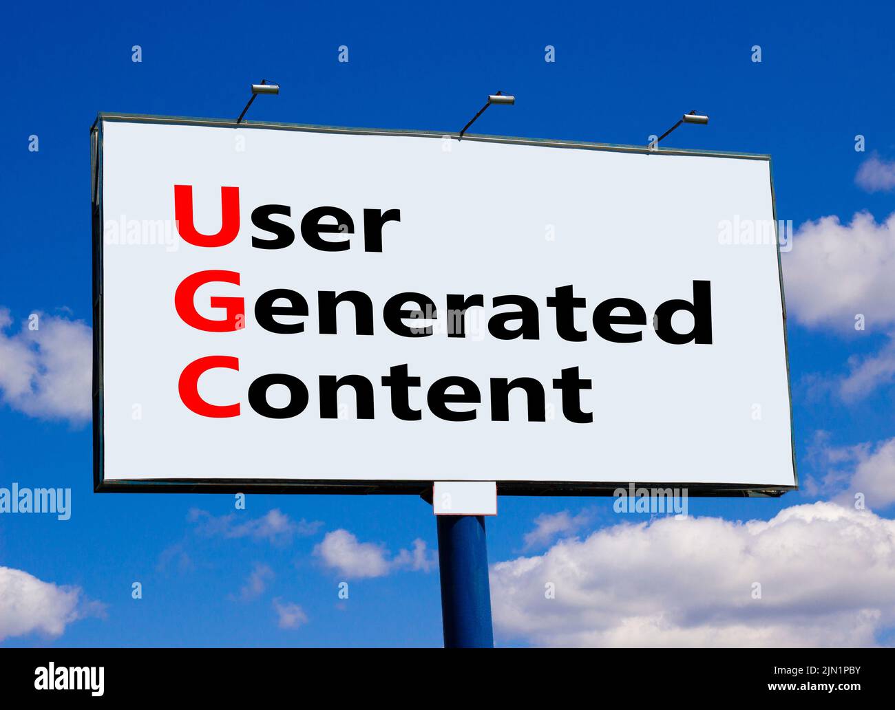 UGC user generated content symbol. Concept words UGC user generated content on white billboard against blue sky, clouds. Beautiful background. Busines Stock Photo