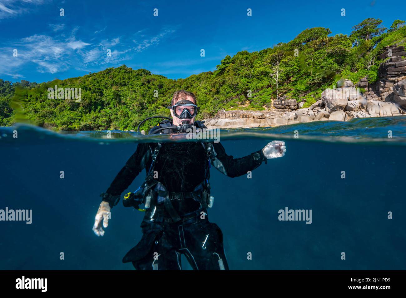 diver surfaces in the tropical waters of the Andaman Sea Stock Photo