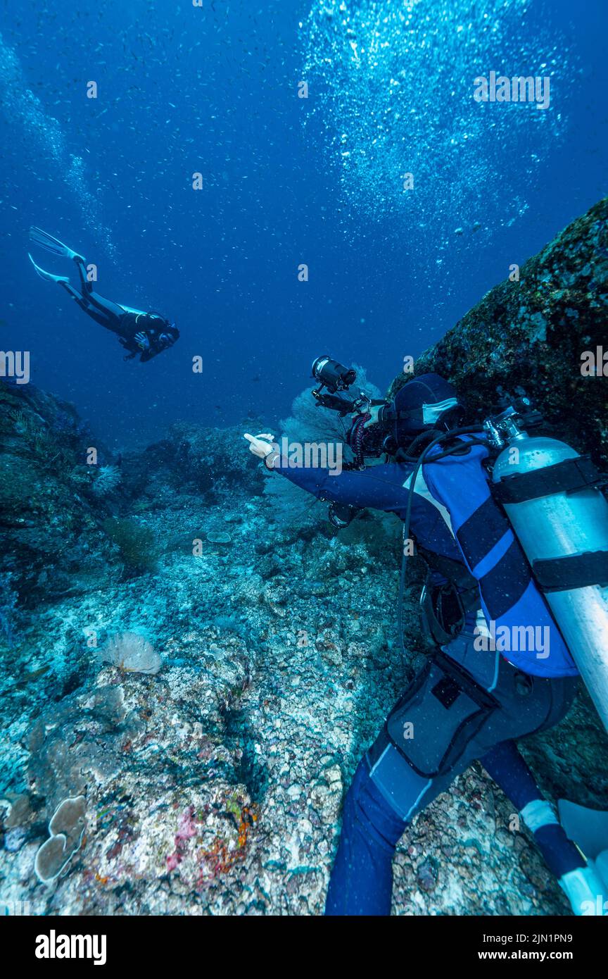 photographer takes picture of model under water Stock Photo