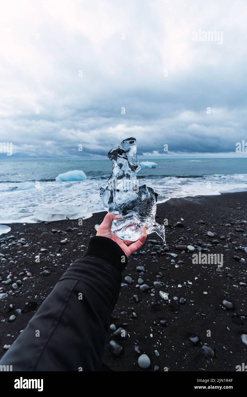 Mans hand holding thin ice hi-res stock photography and images - Alamy