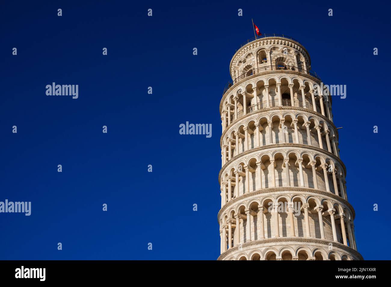 The iconic Leaning Tower of Pisa, one of the most famous ancient building in the world (with blue sky and copy space) Stock Photo