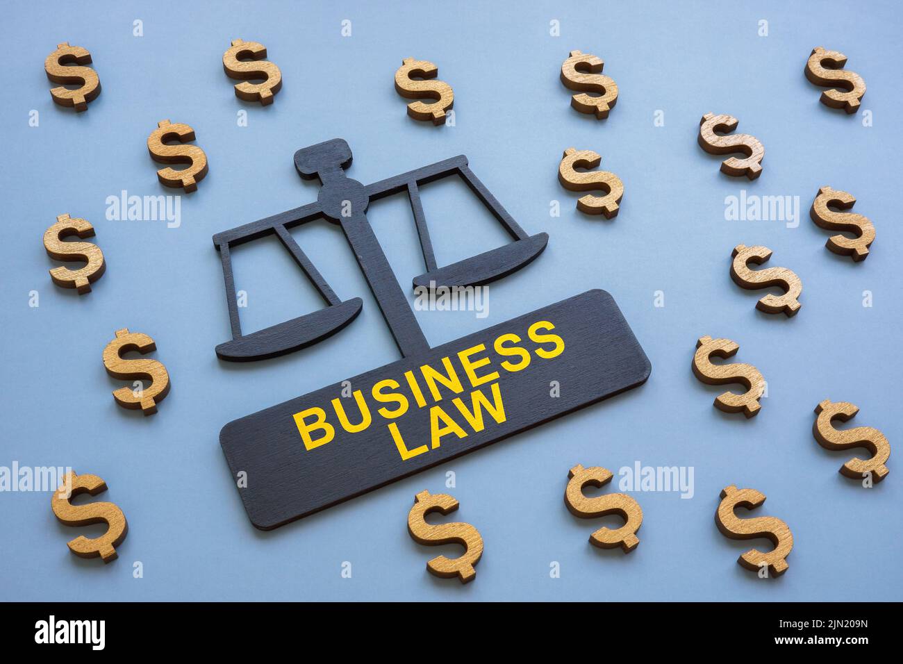 Plate in the form of scales and the inscription business law. Stock Photo