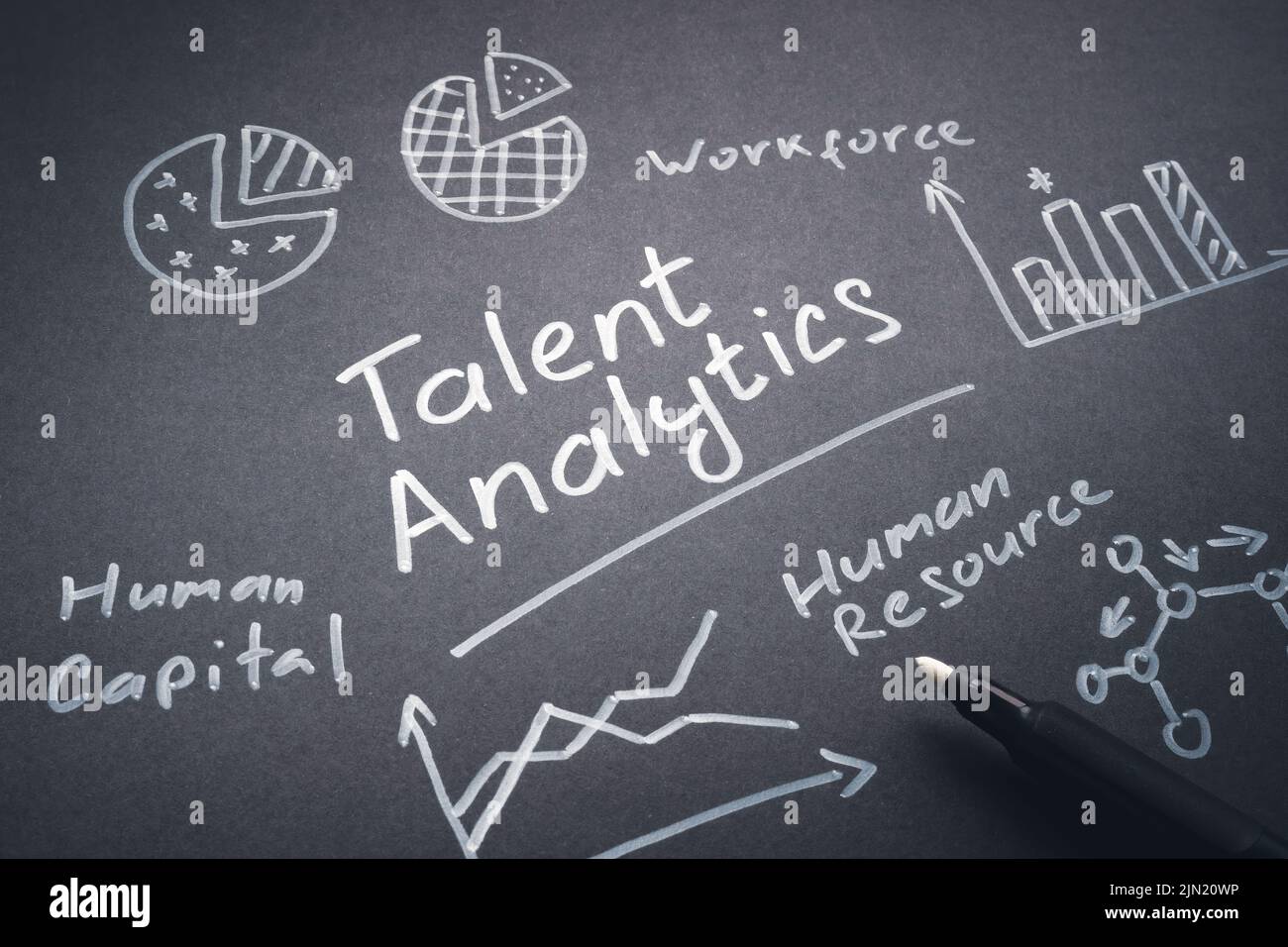 Handwritten talent analysis and charts on the dark page. Stock Photo