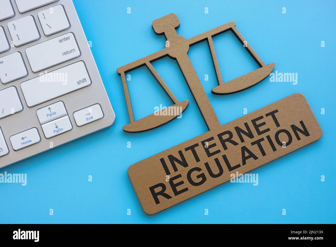 Keyboard and plate in the form of scales with sign internet regulation. Stock Photo