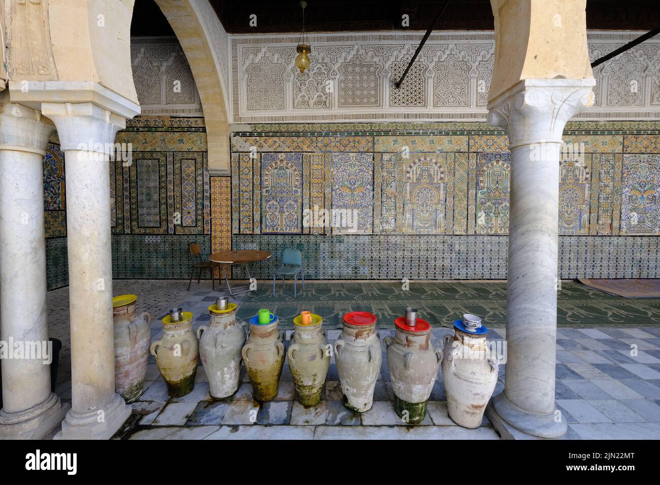 Colourful water pots with mugs in the terrace of Zaouia Sidi Sahab the Barber's Mosque in Kairouan, Tunisia. Stock Photo