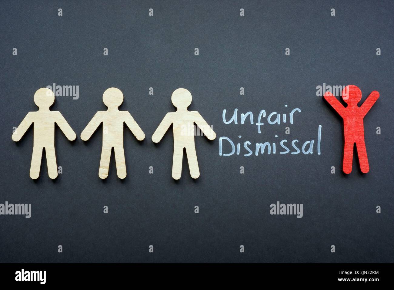 Figures and one red next to the inscription unfair dismissal. Stock Photo