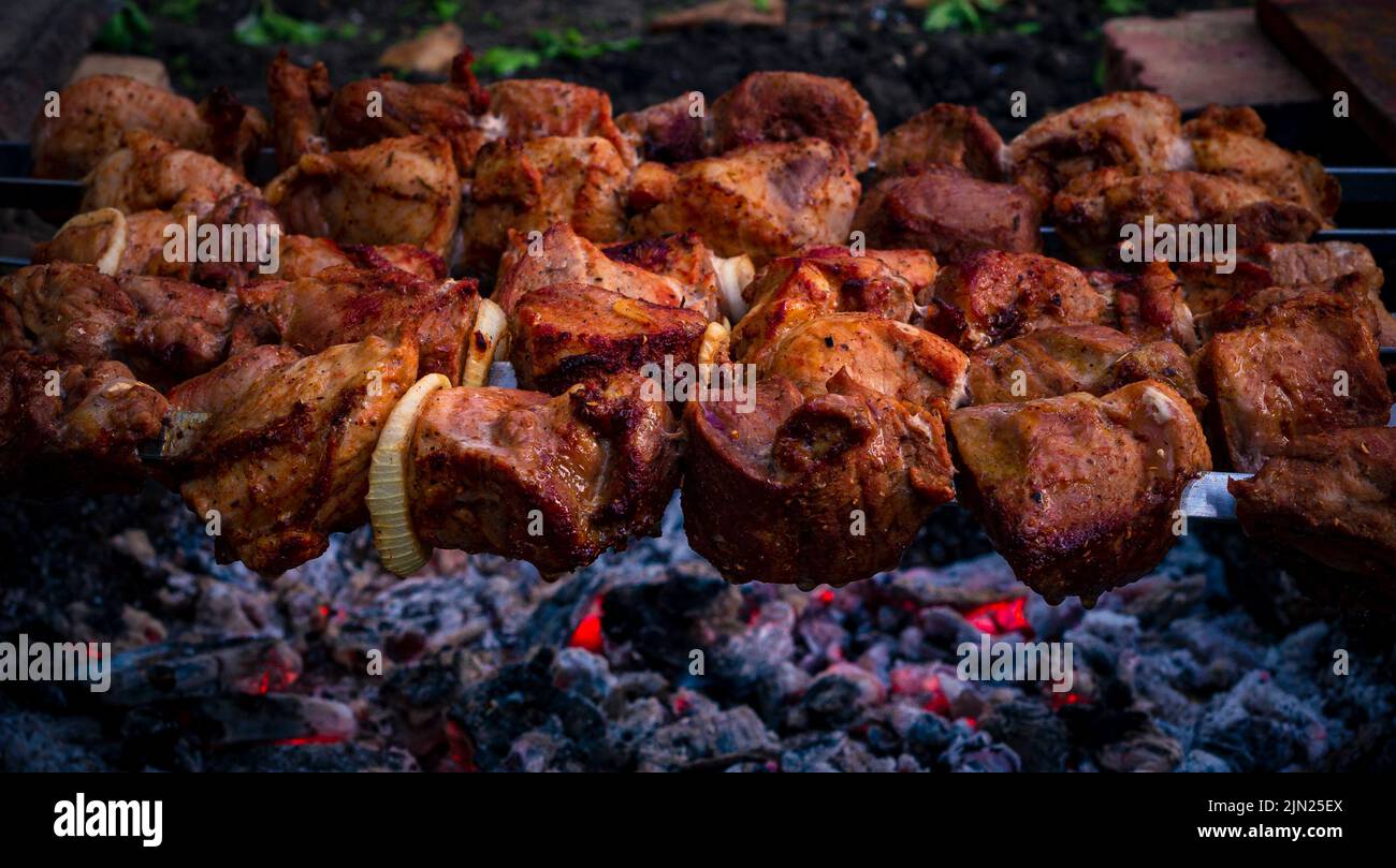 Preparing pork kebab meat skewers, grilled or roasted in a barbecue on