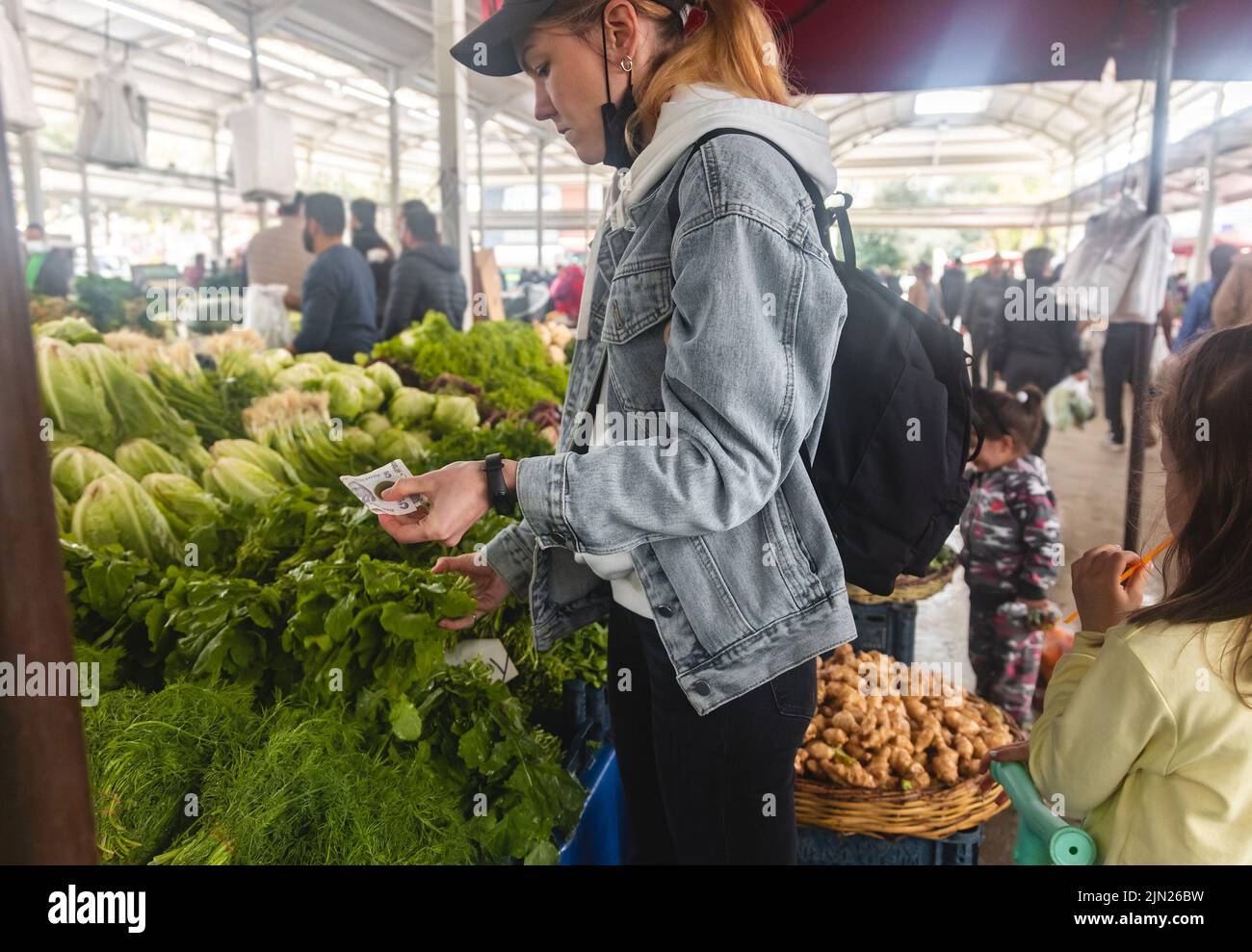 Buying fresh organic produce at the farmers' market. A woman chooses