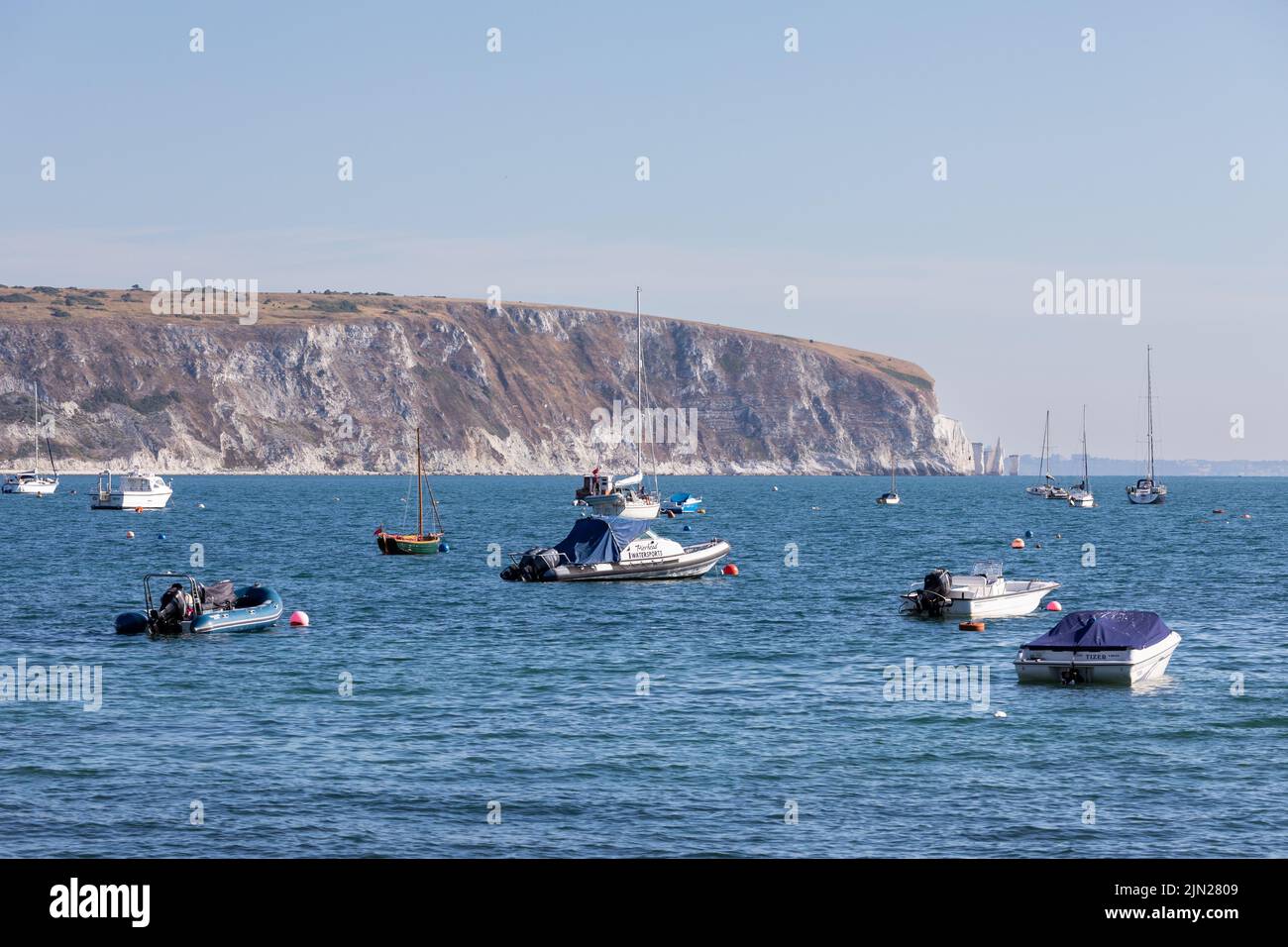 Boats in Swanage Bay in summer with Ballard Down in the background, Dorset, England Stock Photo
