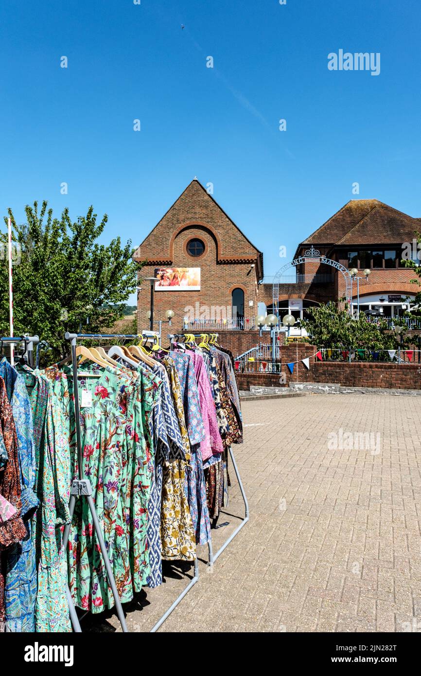 Dorking, Surrey Hills, London UK, July 07 2022, Bright Colourful Womens Dresses Hanging In Outdoor Market Stall With No People Stock Photo