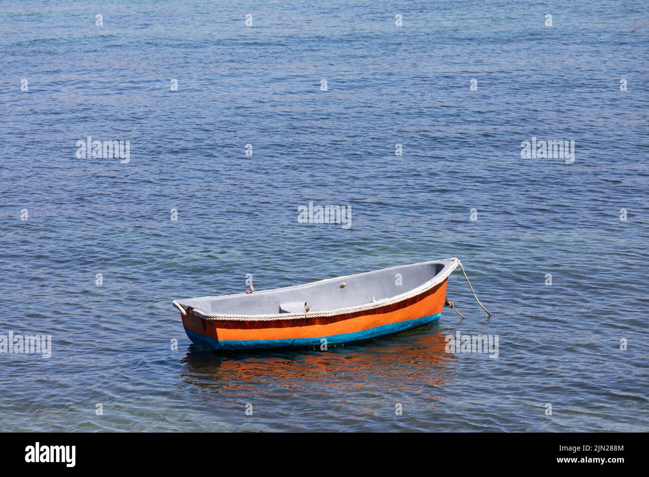 Rowing boat floating in Swanage Bay, Dorset, England, UK Stock Photo