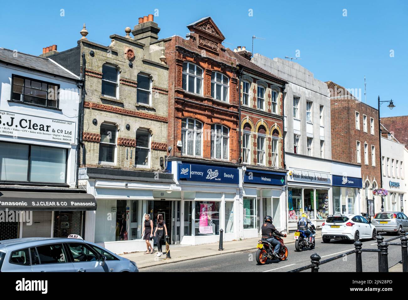 Dorking, Surrey Hills, London UK, July 07 2022, Row of High Street Retail Shops With Traffic Cars And Motorbike On Road Stock Photo