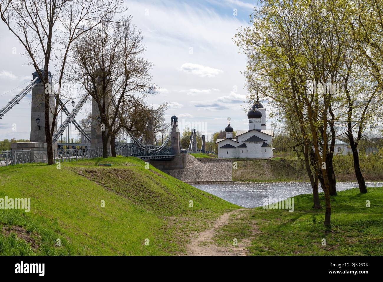 Chain Bridge and the Church of St. Nicholas the Wonderworker in the city of Ostrov, Pskov region, Russia Stock Photo