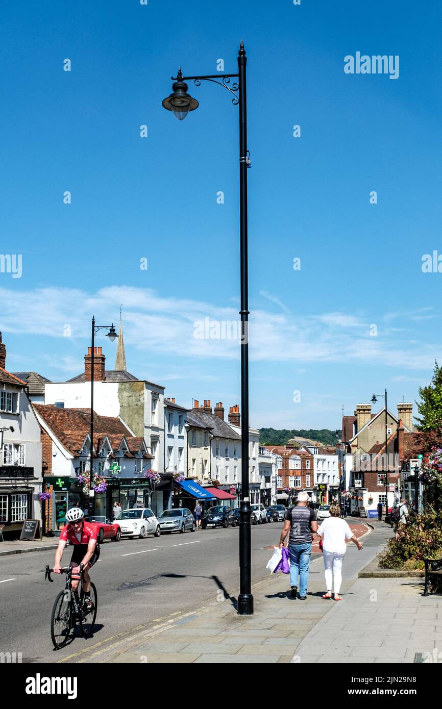 Dorking, Surrey Hills, London UK, July 07 2022, Pedestrians Walking and Cyclist Riding On Road Infront Of A Line Of Retail Shops Stock Photo