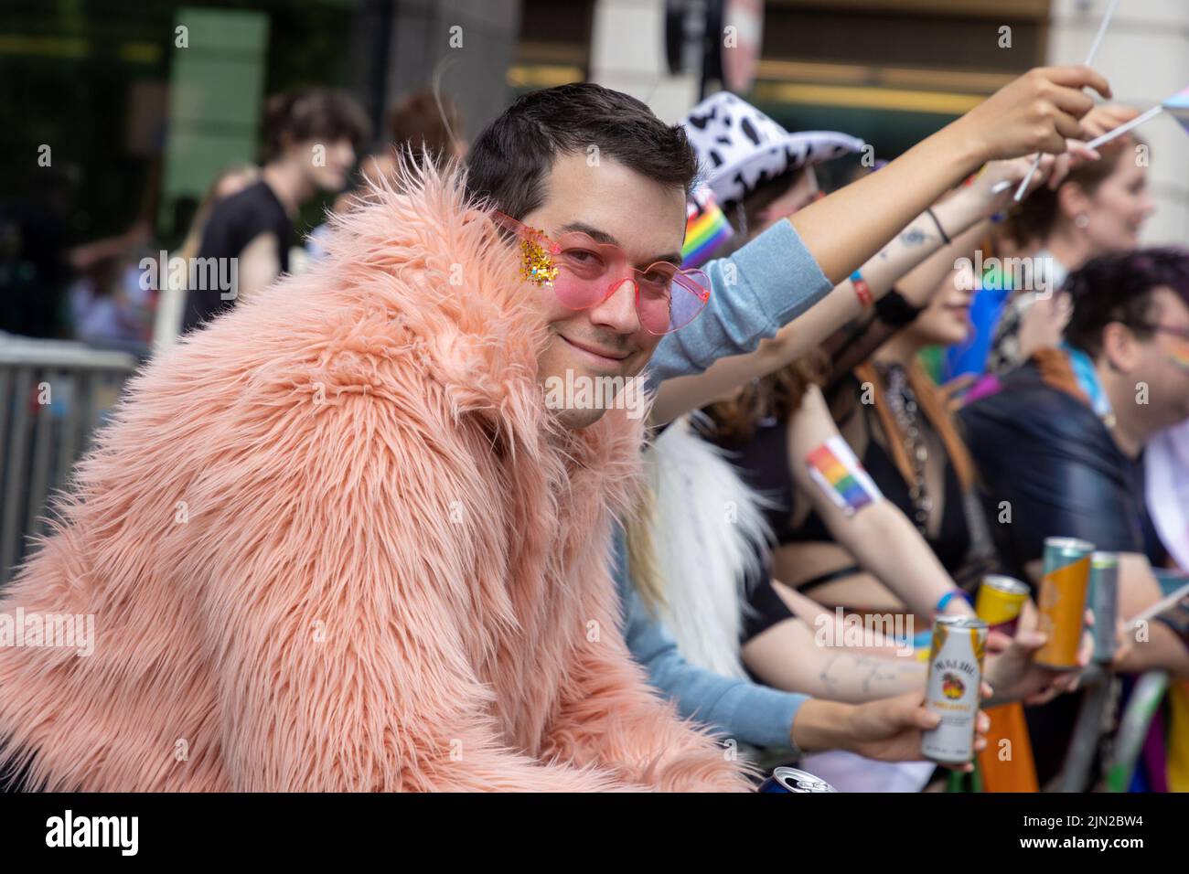 Man with pink heart glasses lines the street as part of London Pride, in Piccadilly. The annual march is a celebration for the lesbian, gay, bi-sexual Stock Photo