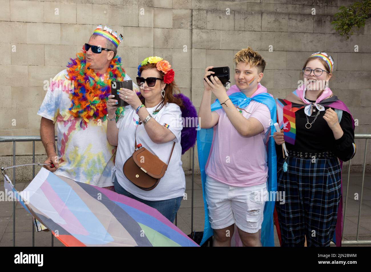 A group taking photos lines the street as part of London Pride, in Piccadilly. The annual march is a celebration for the lesbian, gay, bi-sexual, tran Stock Photo