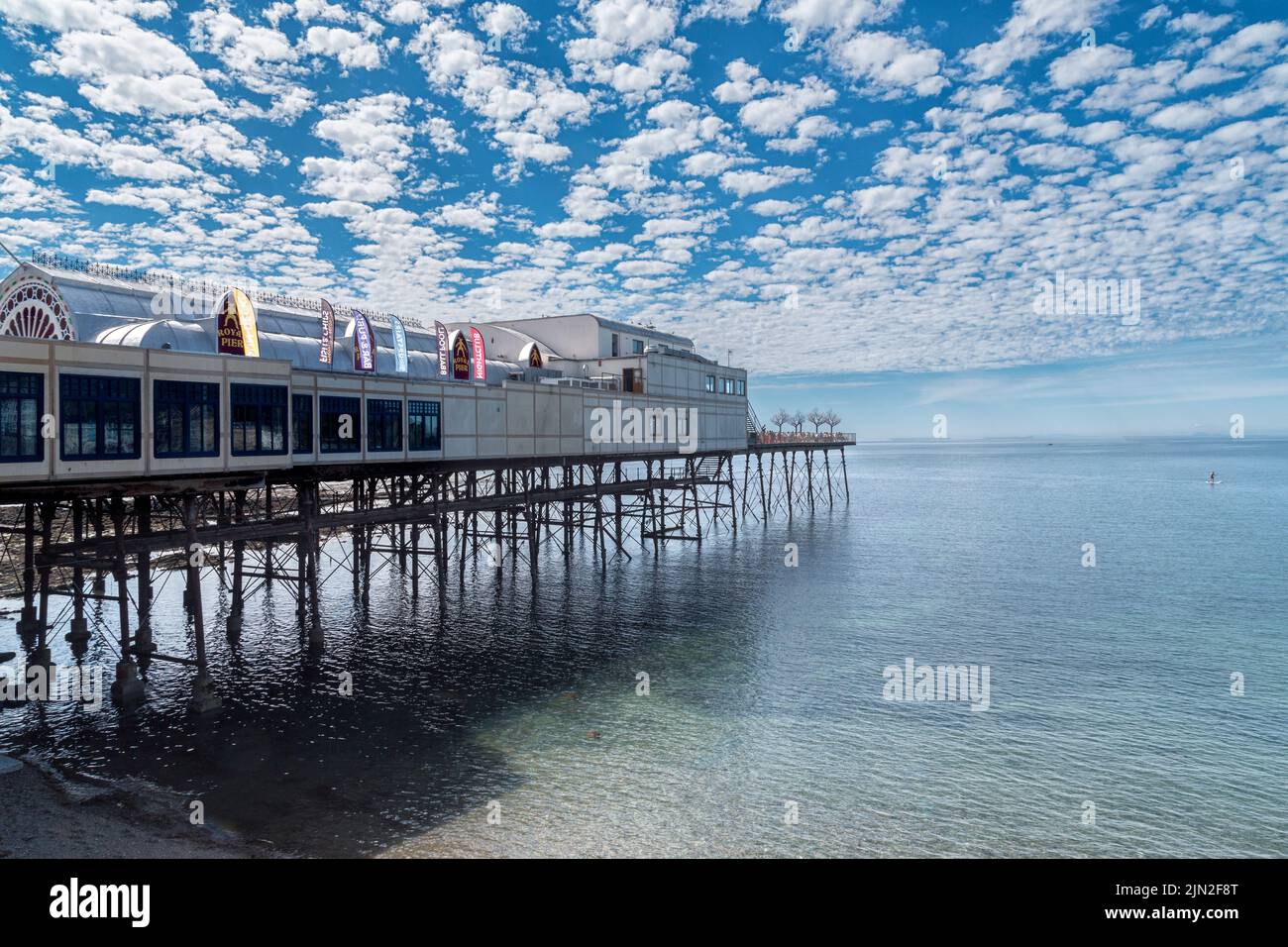 The Royal Pier at Aberystwyth stretching out into the sea toward the horizon. Above it a Mackerel sky aka Altocumulus clouds. Stock Photo