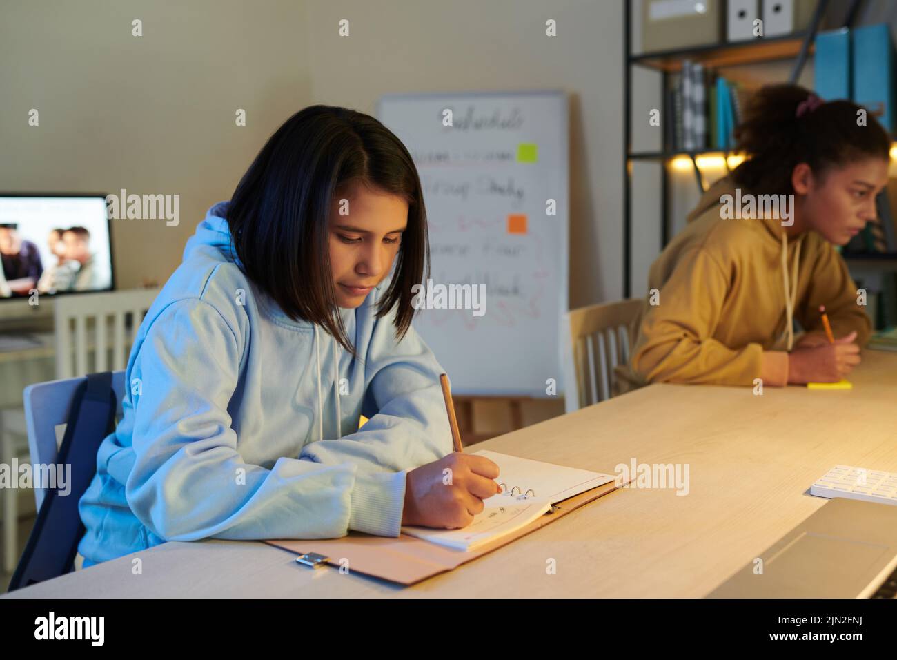 Girl taking notes in class hi-res stock photography and images - Alamy
