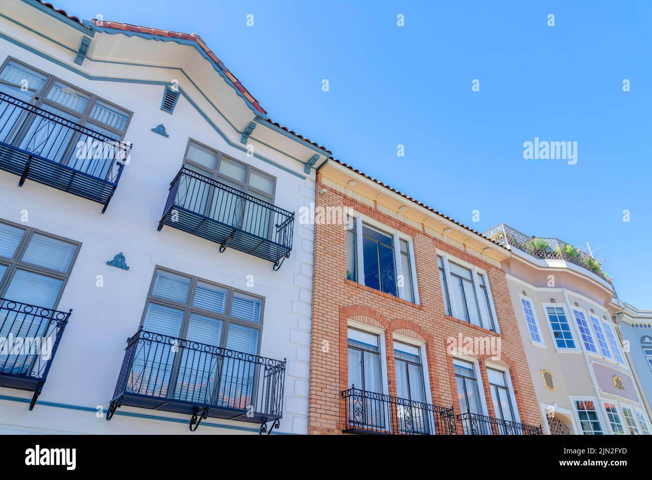 Low angle view of adjacent houses with window railings in San Francisco ...