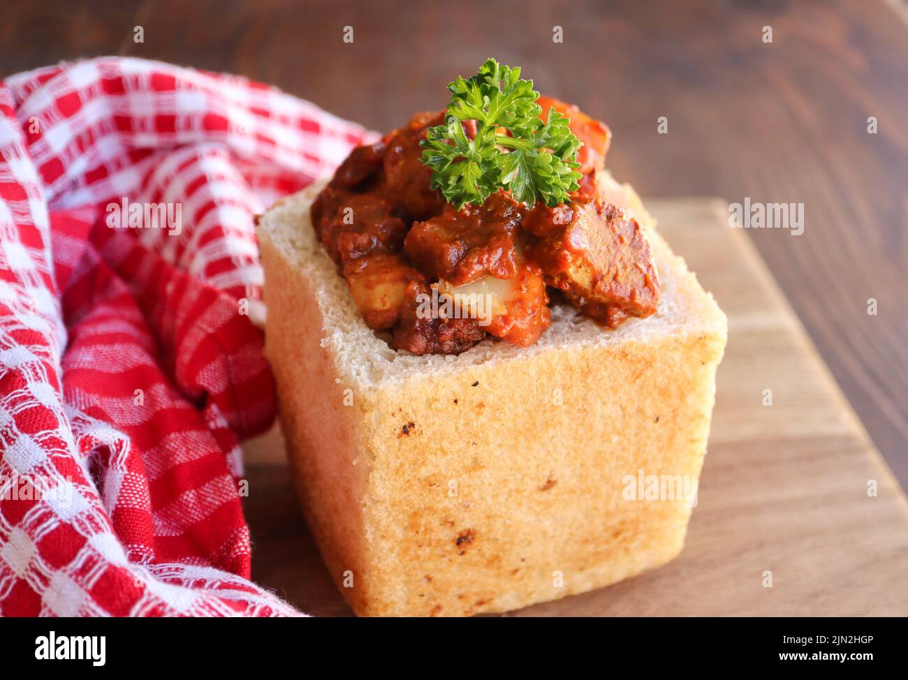 Bunny chow. South African cuisine. Hollowed out loaf of bread filled