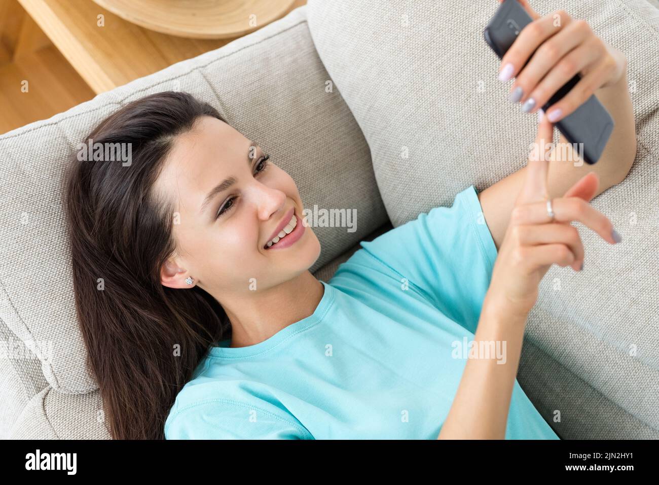 woman using phone idle lifestyle home leisure Stock Photo