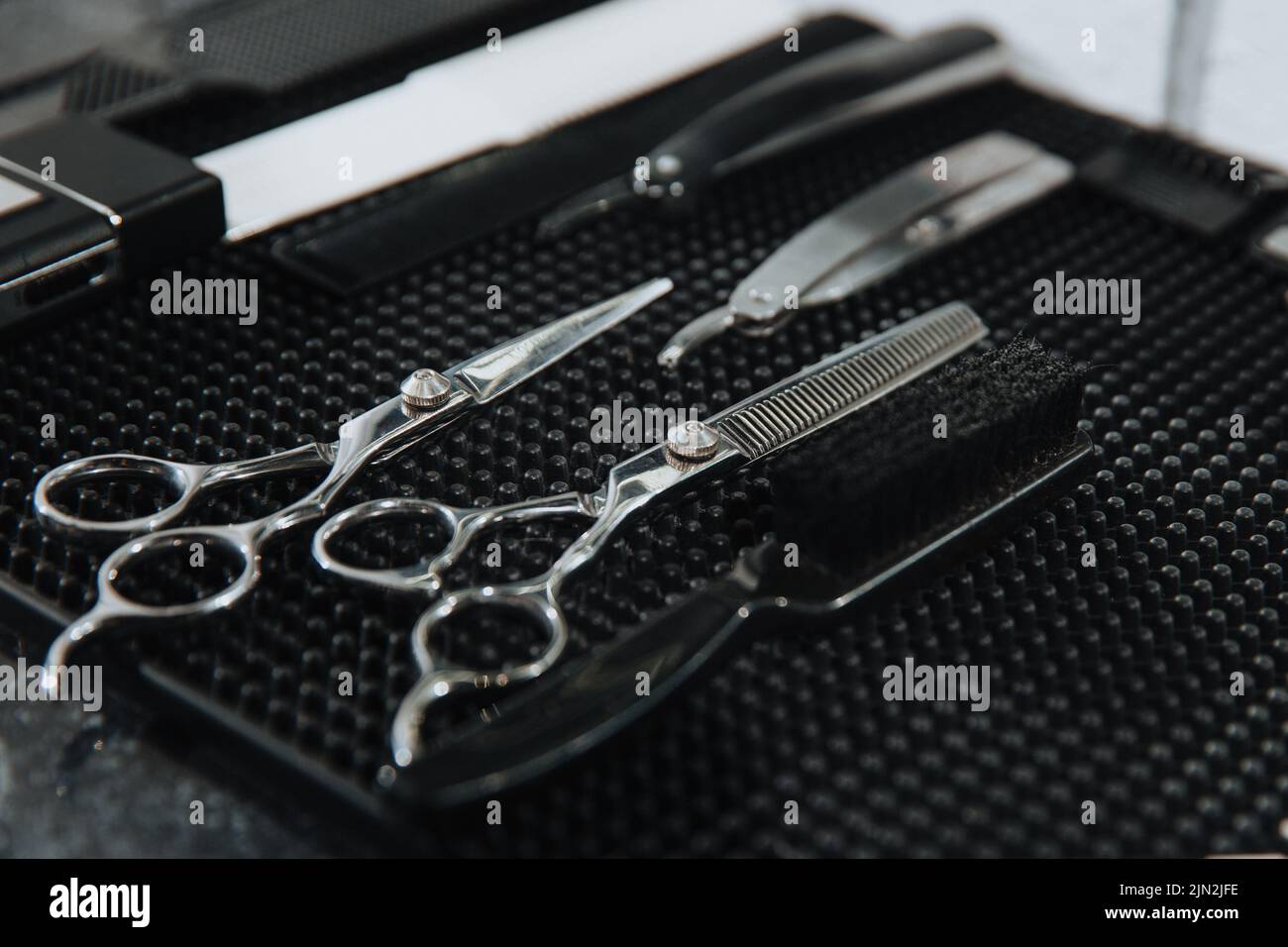 Professional scissors on black background. Hairdressing industry. Professional hairdressing tools. Stock Photo
