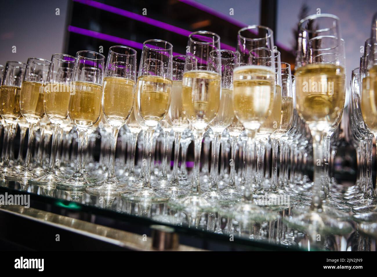 A lot of wine glasses with a cool delicious champagne at the bar. Alcohol background. Party and holiday celebration concept Stock Photo