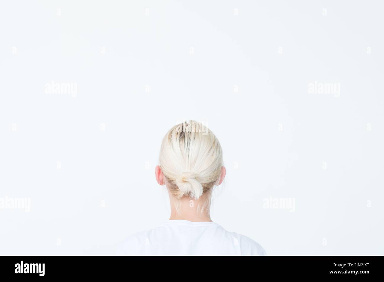 backview woman looking invisible object white Stock Photo