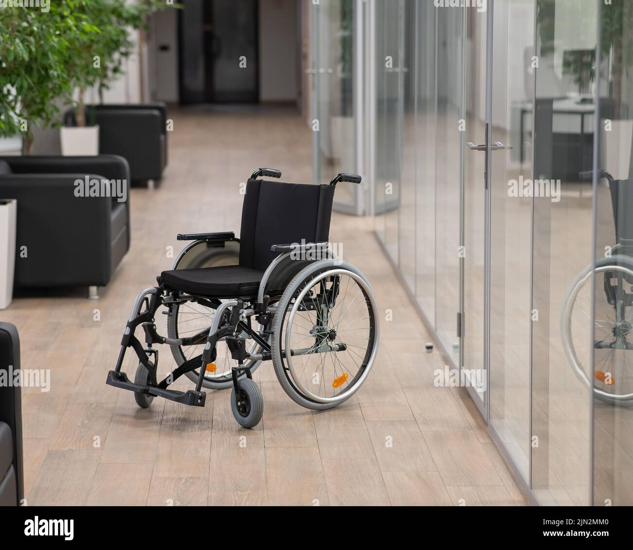 Empty wheelchair in the hallway in the office Stock Photo Alamy