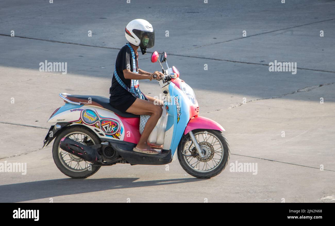 SAMUT PRAKAN, THAILAND, JUNE 02 2022, A motorcyclist with helmet rides
