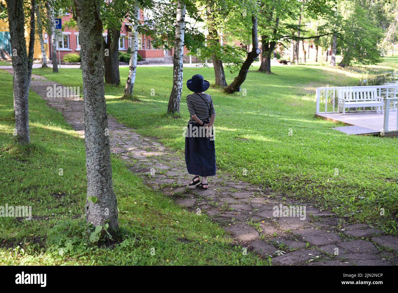 Back view young woman walks hi-res stock photography and images - Alamy