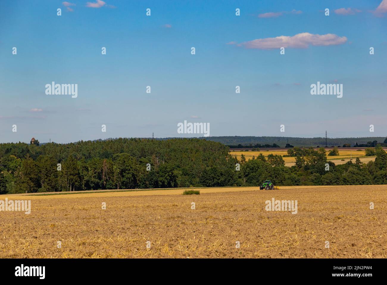 A tractor is harvesting in the field Stock Photo - Alamy