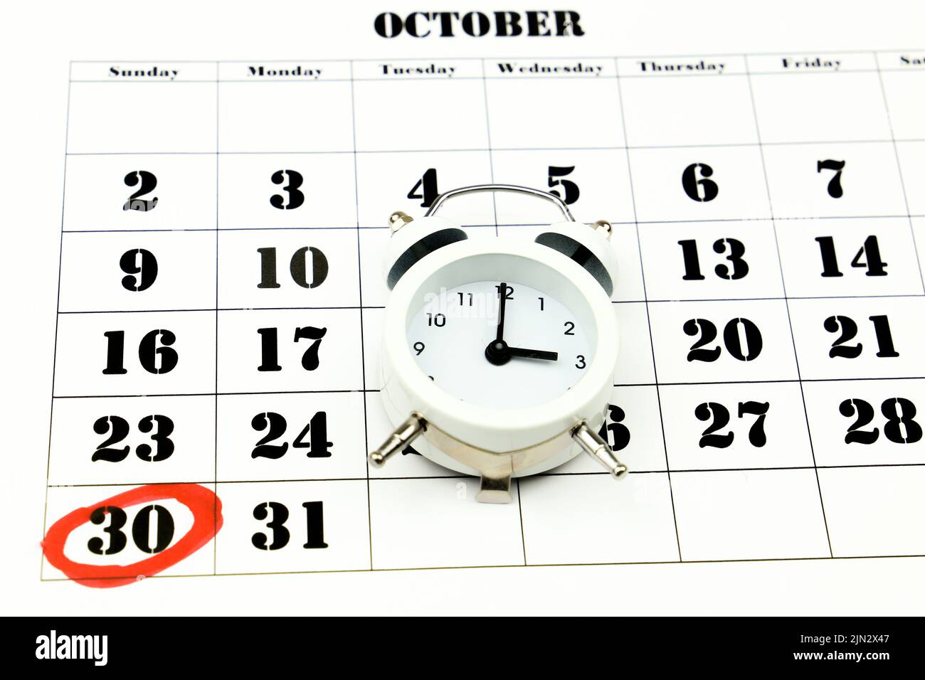Clock marking winter time change over october calendar Stock Photo Alamy