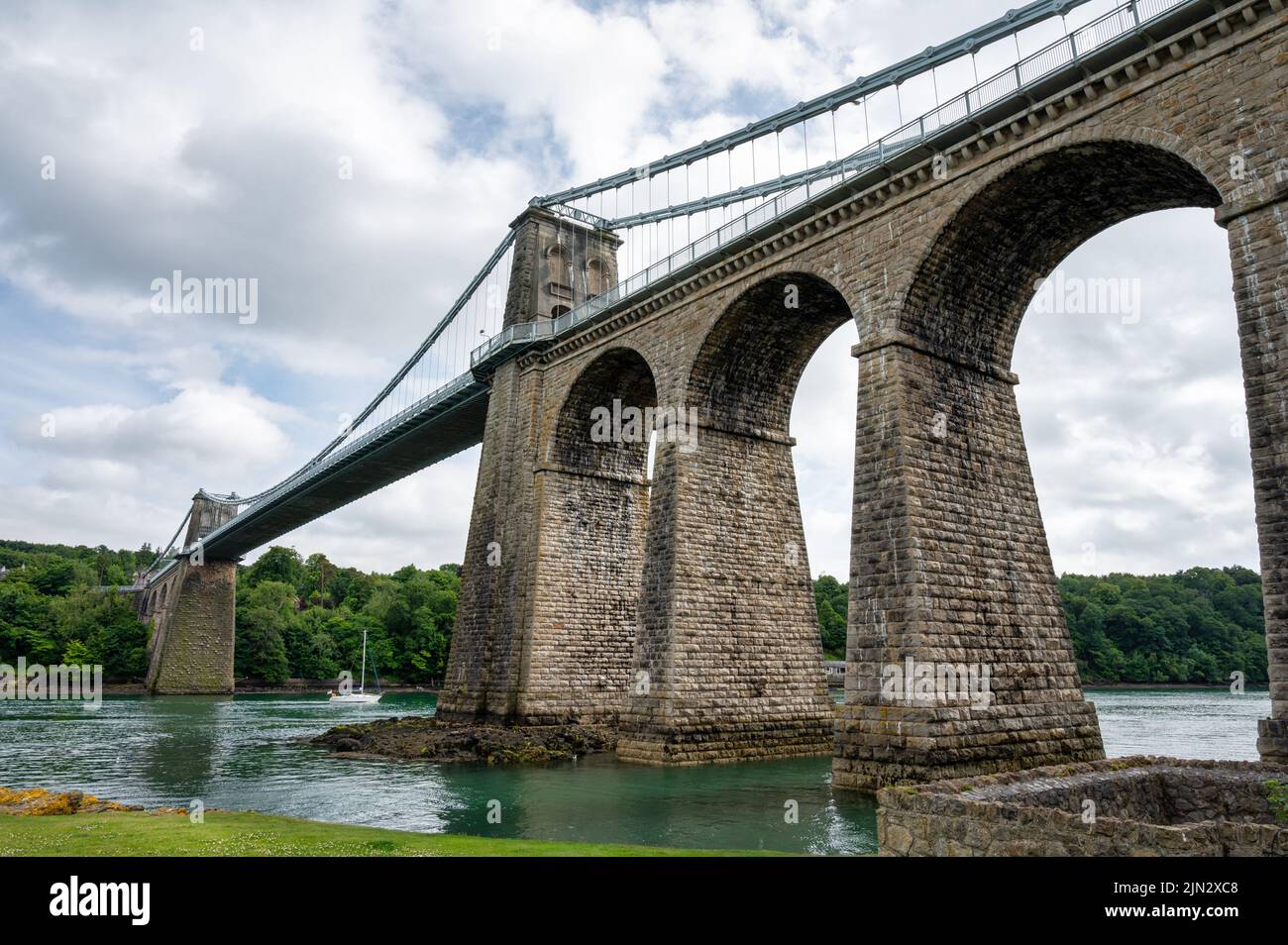 Menai Suspension Bridge built by Thomas Telford that connects the Island of Anglesey to mainland Wales Stock Photo