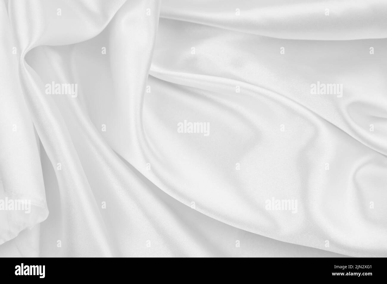 Close-up of rippled white silk fabric texture background Stock Photo