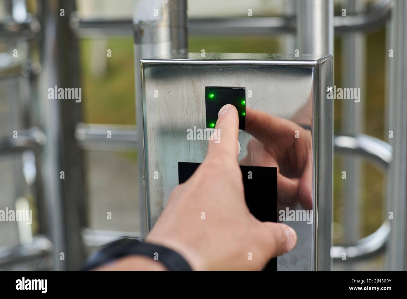 Hand pressing a fingerprint reader to open a security door Stock Photo ...