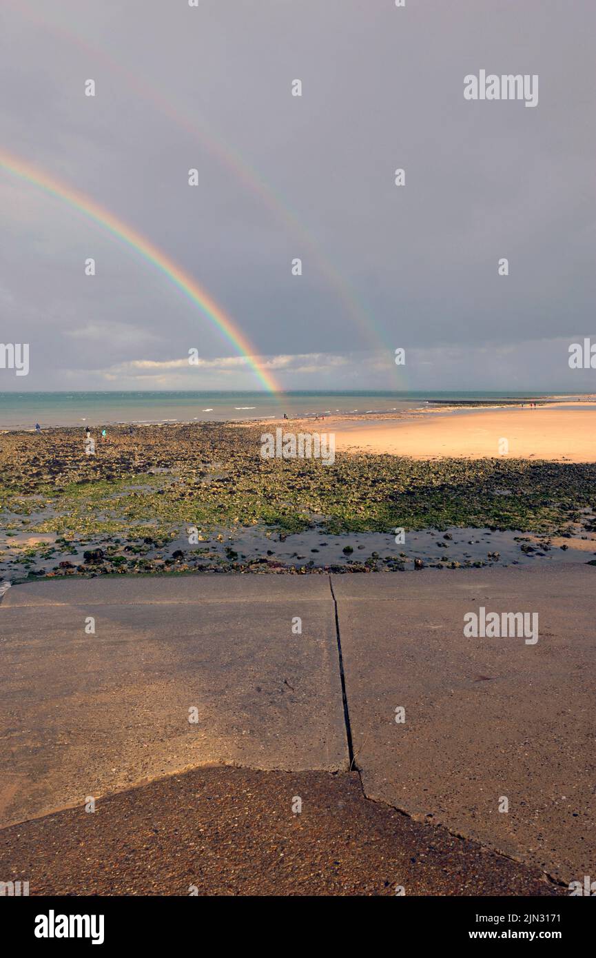 rainbow over beach at west runton north norfolk england Stock Photo