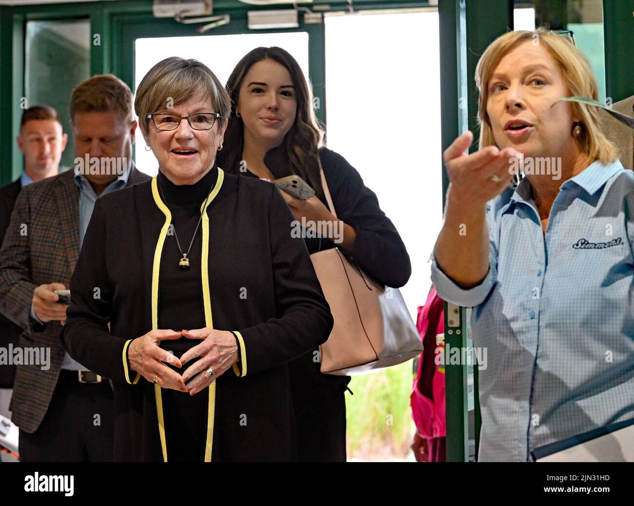 EMPORIA, KANSAS - AUGUST 8, 2022 Kansas Governor Laura Kelly arrives at the Simmons Pet food plant during her Prosperity on the Plains Tour stop in Emporia today and is shown into the event by Julie Maus the Director Of Communications for Simmons Stock Photo