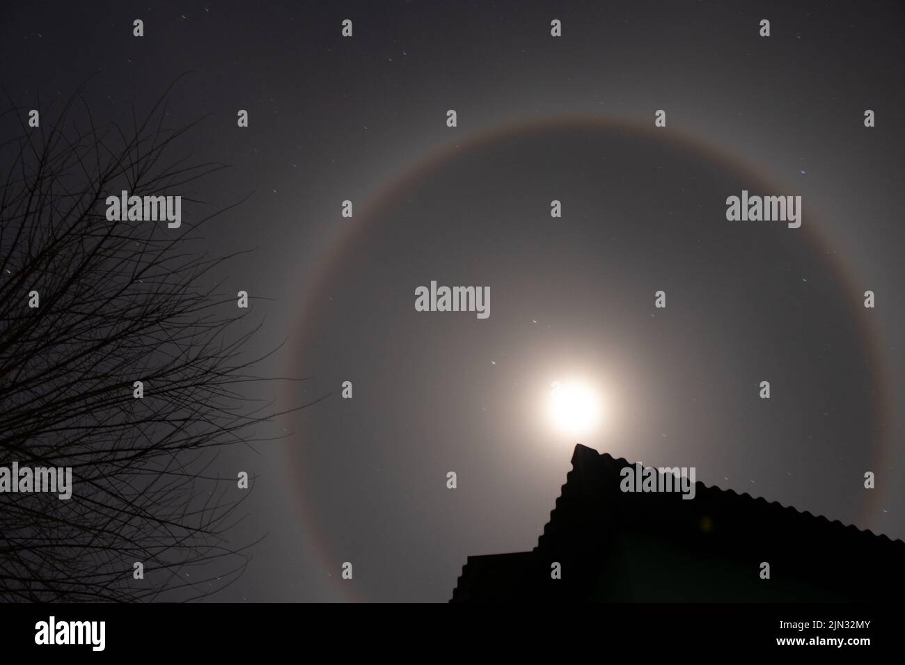 Halo phenomenon on the moon over Ukraine at night during the war in the country 2022, night moon and stars as a background Stock Photo