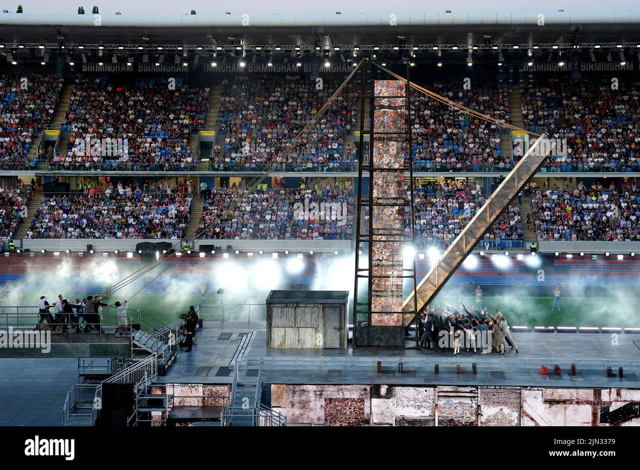 A light column is erected by performers on stage during the Closing Ceremony for the 2022 Commonwealth Games at the Alexander Stadium in Birmingham. Picture date: Monday August 8, 2022. Stock Photo