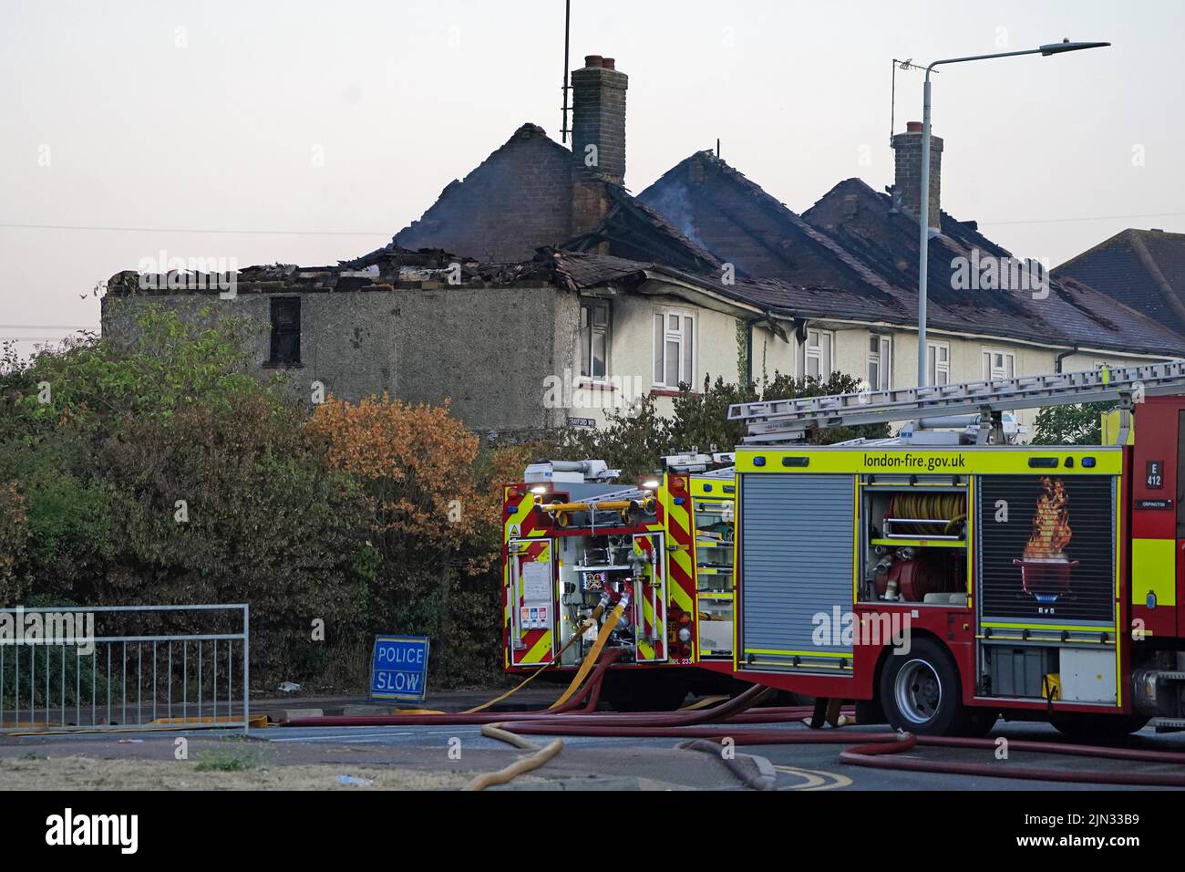 Emergency services at the scene in Crayford Way, Crayford, south east London, where firefighters have been tackling a blaze which ripped through four terraced houses Picture date: Monday August 8, 2022. Stock Photo